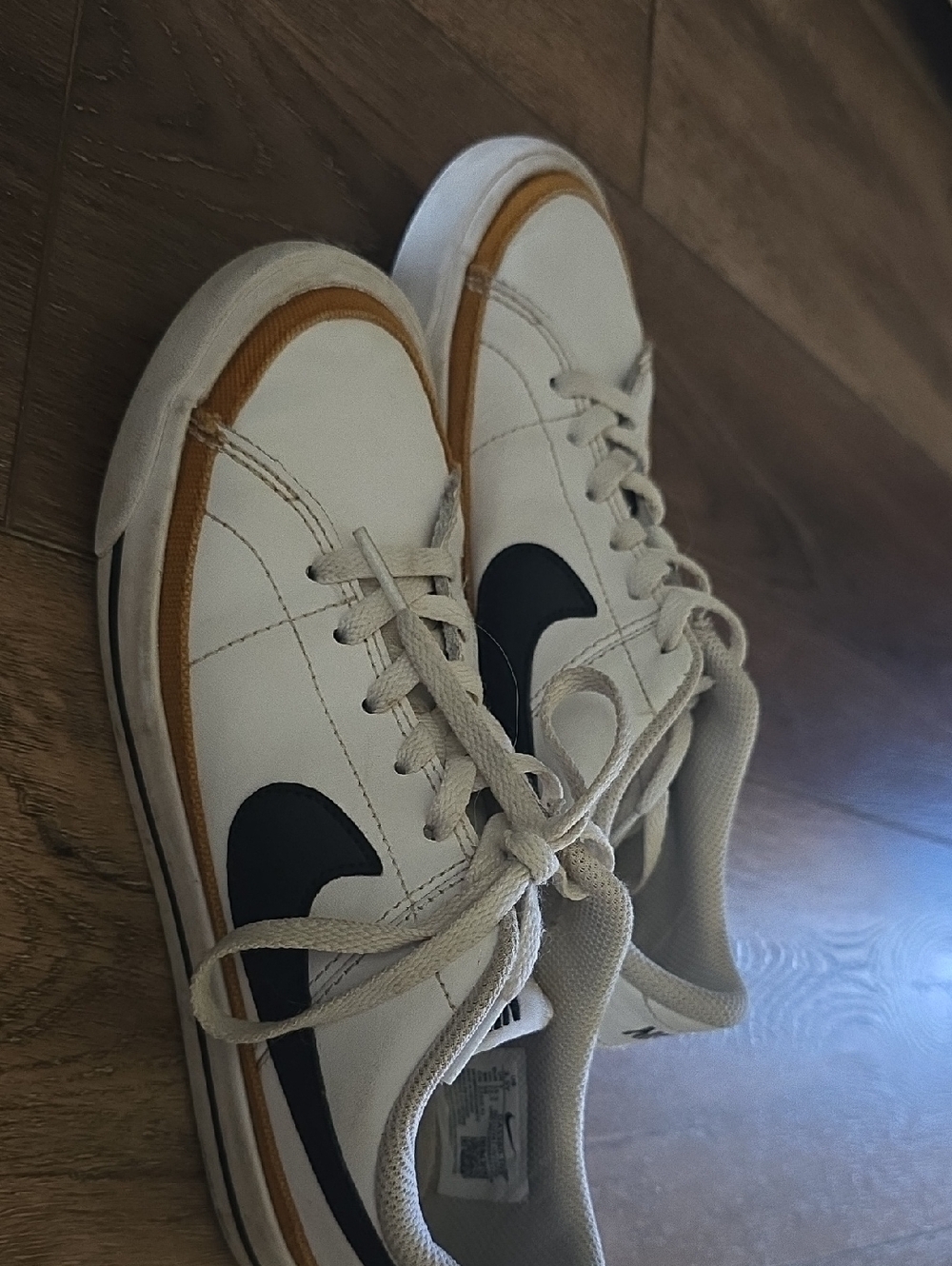 Nike White Low-Top Sneakers with Black Swoosh and Tan Accent